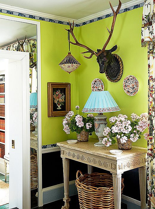 The lime-green walls play up the whimsy in this nook’s juxtaposition of unlikely objects (including the lantern hanging from an antler). Photo by Tony Vu.
